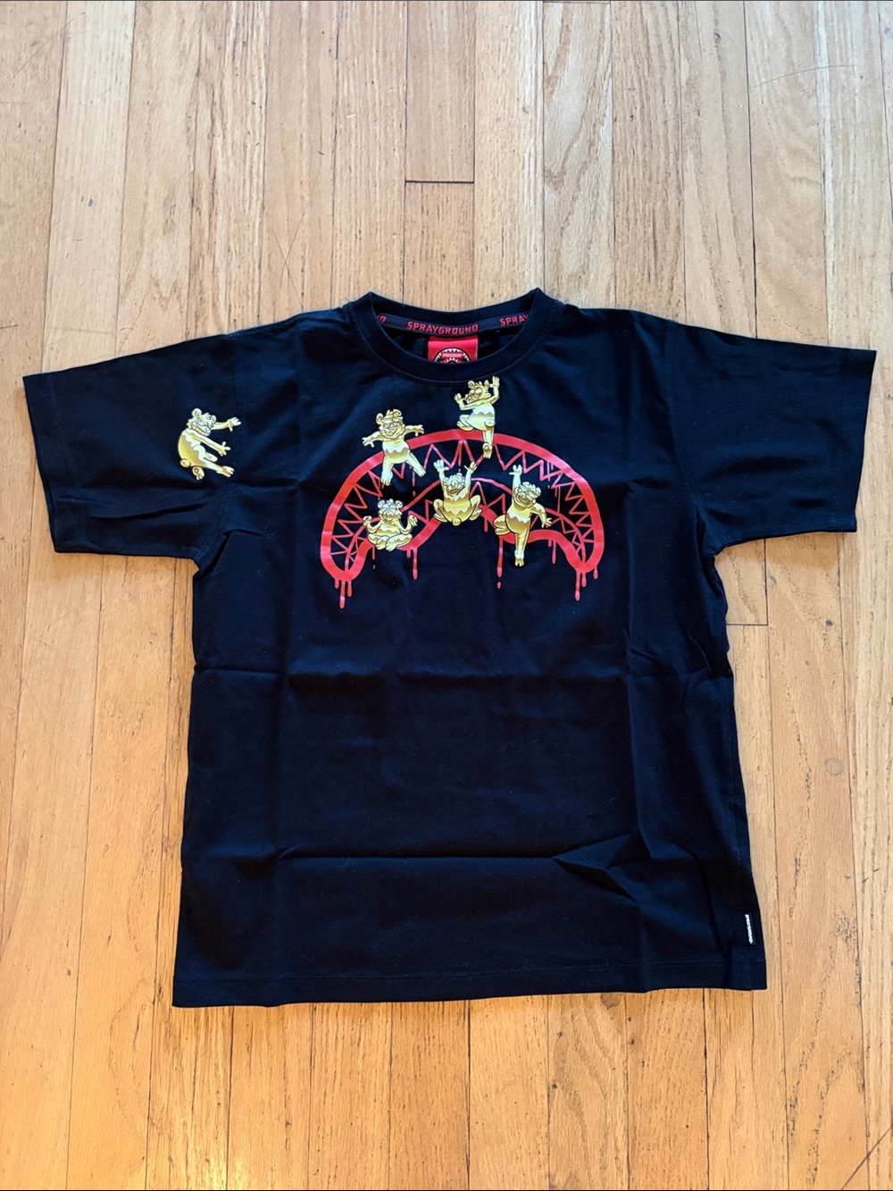 Sprayground Kids Black Tee with Yellow Character Graphic and Red Arch